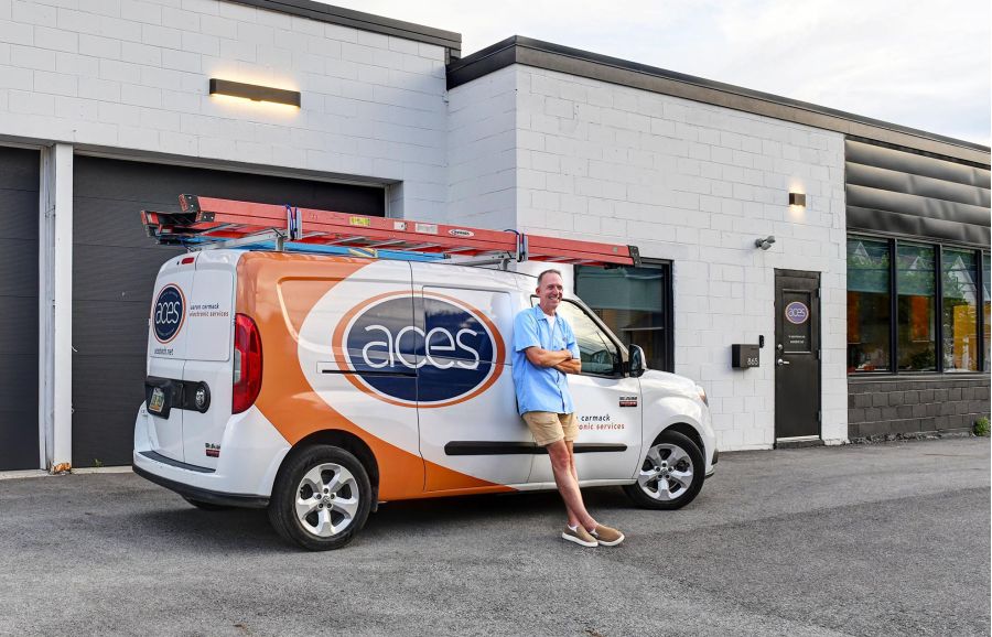 Aaron Carmack leaning against his service van
